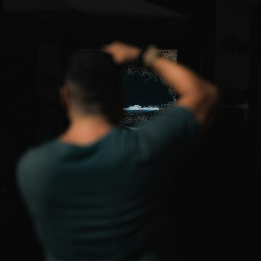 Turkish man editing video footage on a dual monitor setup