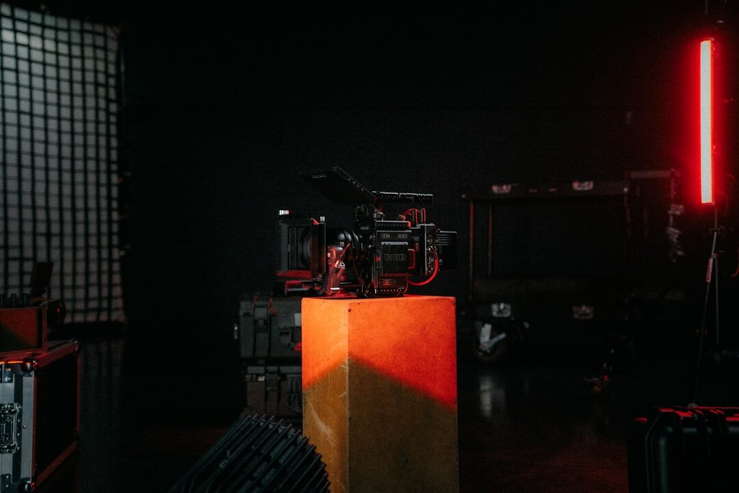 Film set with a clapperboard and camera on a tripod in dim studio lighting
