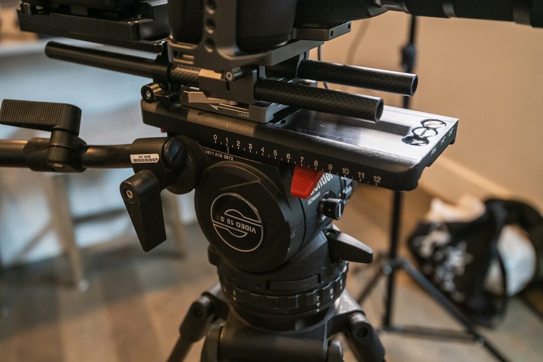 Professional video camera mounted on a tripod in a filming studio